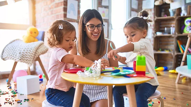 Childcare teacher with two toddlers